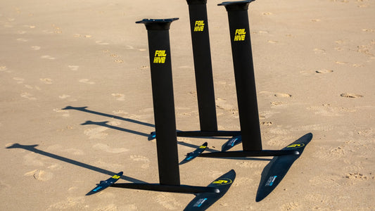 Range of foil front wings laid out on Tarifa sand