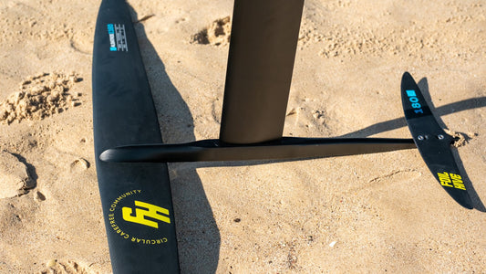 Surf foil close-up on Tarifa sand with wave context