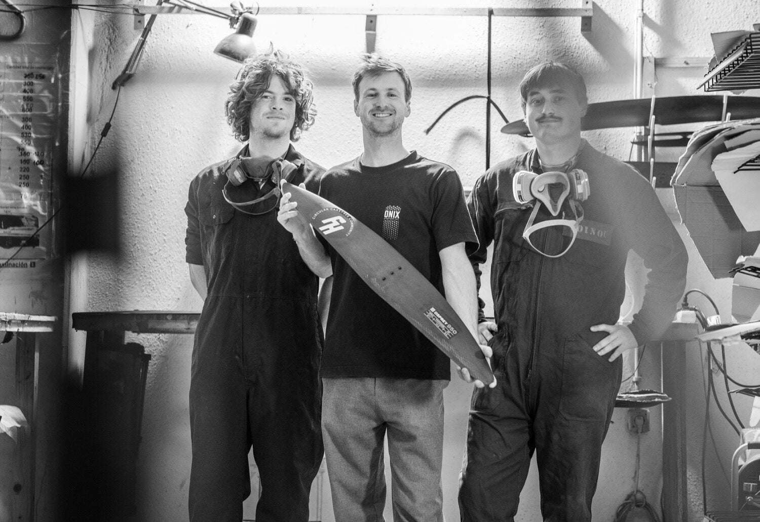 The FoilHive team holding a freshly built wing in the Tarifa workshop